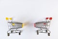 Two small empty decorative shopping carts with yellow, red accents on white background, place for text. View from above. Mockup, Royalty Free Stock Photo