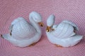 Two small figurine of a white ceramic swans