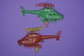 Two small green red plastic toys helicopters