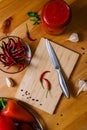 two small hot peppers on a bamboo cutting board - preparation for the sauce. Paprika, tomatoes, garlic and spices Royalty Free Stock Photo