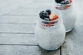 Two small jars of chia pudding, yogurt and fresh fruits: Strawb Royalty Free Stock Photo