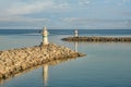 Two small jetty lighthouses at the entrance of a small harbor