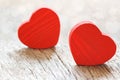 Two small red hearts made of wooden on bright white lights bokeh background. Valentine day background Royalty Free Stock Photo