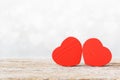 Two small red hearts made of wooden on bright white lights bokeh background Royalty Free Stock Photo