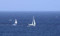 Two small sailing yachts on the blue ocean Royalty Free Stock Photo