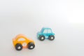 Two small toy cars yellow and blue, with white background Royalty Free Stock Photo