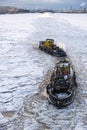 Aint Petersburg, Russia - 28.18.2022 two small vintage icebreaker ships make their way through the frozen icy sea Royalty Free Stock Photo