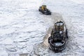 Aint Petersburg, Russia - 28.18.2022 two small vintage icebreaker ships make their way through the frozen icy sea Royalty Free Stock Photo