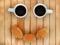 Two small white cups of coffee and three croissants look like smiling face Royalty Free Stock Photo