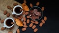 Coffee with croissants, chocolate and sweets on a dark background. Top view