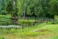 Two small wooden bridges between small ponds in a well-kept beautiful park Royalty Free Stock Photo