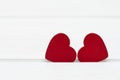 Two red wooden hearts on white wooden background. Valentine`s day or Love concept. Royalty Free Stock Photo