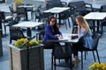 Two cooperative workers are sitting in cafe with paperworks