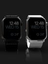 2 smart watches - Apple Watch 4, silver and black, on dark Royalty Free Stock Photo