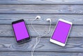 Two smartphones with a pink screen, headphones