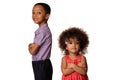 Two smiling african american siblings standing back to back with arms crossed, isolated on white