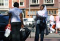 Two smiling African black women speaking on the street