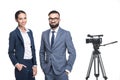 two smiling announcers standing near tv video camera, Royalty Free Stock Photo