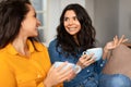 Two Smiling Besties Ladies Talking Sitting With Tea Cups Indoor