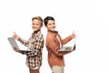 Two smiling brothers holding laptops, showing thumbs up and looking at camera Royalty Free Stock Photo