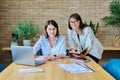 Two smiling business women looking at camera in office Royalty Free Stock Photo