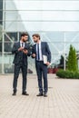 Two smiling businessman colleagues in a blue suit talking and walking business people discussing strategy Royalty Free Stock Photo