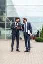 Two smiling businessman colleagues in a blue suit talking and walking business people discussing strategy Royalty Free Stock Photo