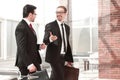 Two smiling businessman walking in the office hall Royalty Free Stock Photo