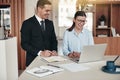 Two smiling businesspeople working together in an modern office Royalty Free Stock Photo