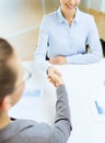 Two smiling businesswoman shaking hands in office Royalty Free Stock Photo