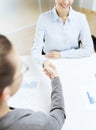 Two smiling businesswoman shaking hands in office Royalty Free Stock Photo