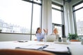 Two smiling businesswomen high fiving each other in an office Royalty Free Stock Photo