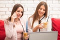 Two smiling businesswomen using laptop in a cafe Royalty Free Stock Photo