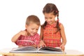 Two smiling children reading the book on the desk Royalty Free Stock Photo