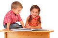 Two smiling children reading the book on the desk Royalty Free Stock Photo