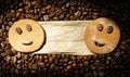 Two smiling cookies on package label with roasted coffee beans Royalty Free Stock Photo