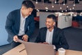 Two smiling coworkers working together on project in modern office Royalty Free Stock Photo