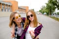 Two smiling female friends hugging each other on the street. Holidays, vacation, love and friendship concept Royalty Free Stock Photo