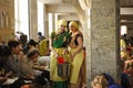 Two smiling female kitchen workers give to parishioners Prasad - food that is a religious offering in Krishnaism