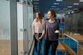 Two smiling female squash players in gym