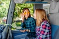 smiling girl friends with map traveling by tour in bus Royalty Free Stock Photo