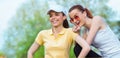 Two smiling girl friends in sports clothing drinking water Royalty Free Stock Photo