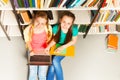 Two smiling girls portrait from above in library Royalty Free Stock Photo