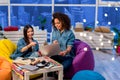 Two smiling girls watching at laptop