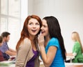 Two smiling girls whispering gossip Royalty Free Stock Photo