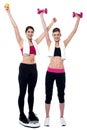 Two smiling girls working out together Royalty Free Stock Photo