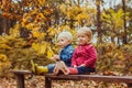 Two smiling happy kids friends, boy and girl sitting on the bench Royalty Free Stock Photo