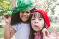 Two smiling happy little girl wear party hat eat candy Royalty Free Stock Photo