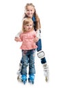 Two smiling little girls on rollerskates