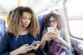 Two smiling lovely girls using a smartphone Royalty Free Stock Photo